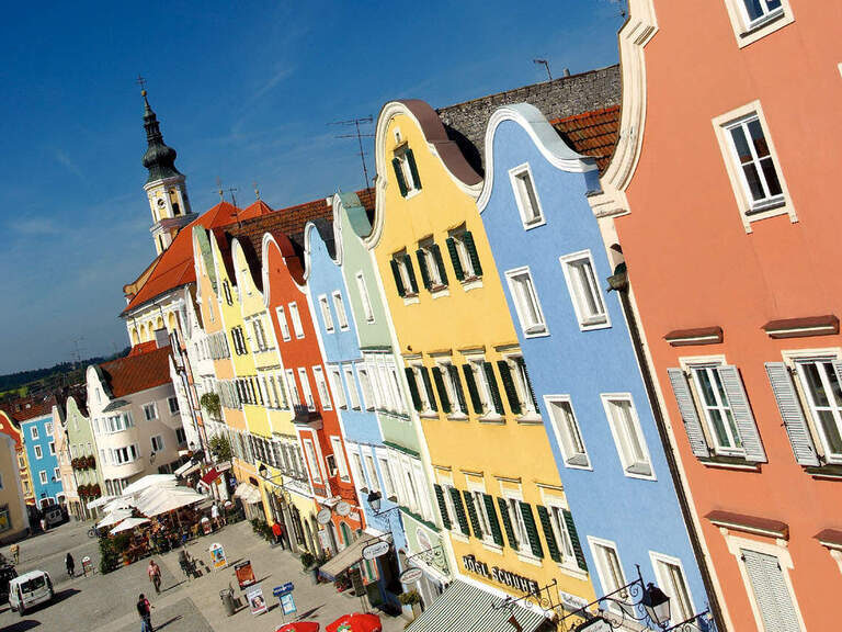 Eine Häuserreihe in der Innenstadt in Bad Birnbach mit blauen Himmel im Hintergrund.